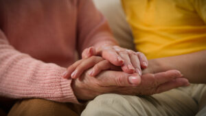 hands lovingly clasped while discussing final expense insurance