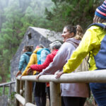 Group of women with different ages and ethnicities having fun walking in the woods enjoying cool weather activities