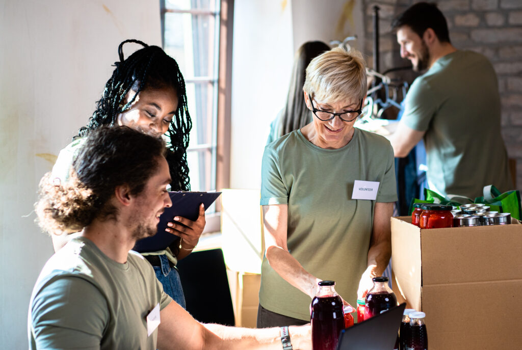 A group sands together boxing canned goods at a food pantry, just one of several volunteer opportunities for retirees