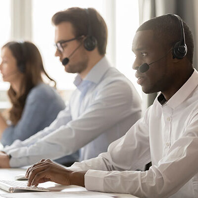 brokers agents with headsets working on computers